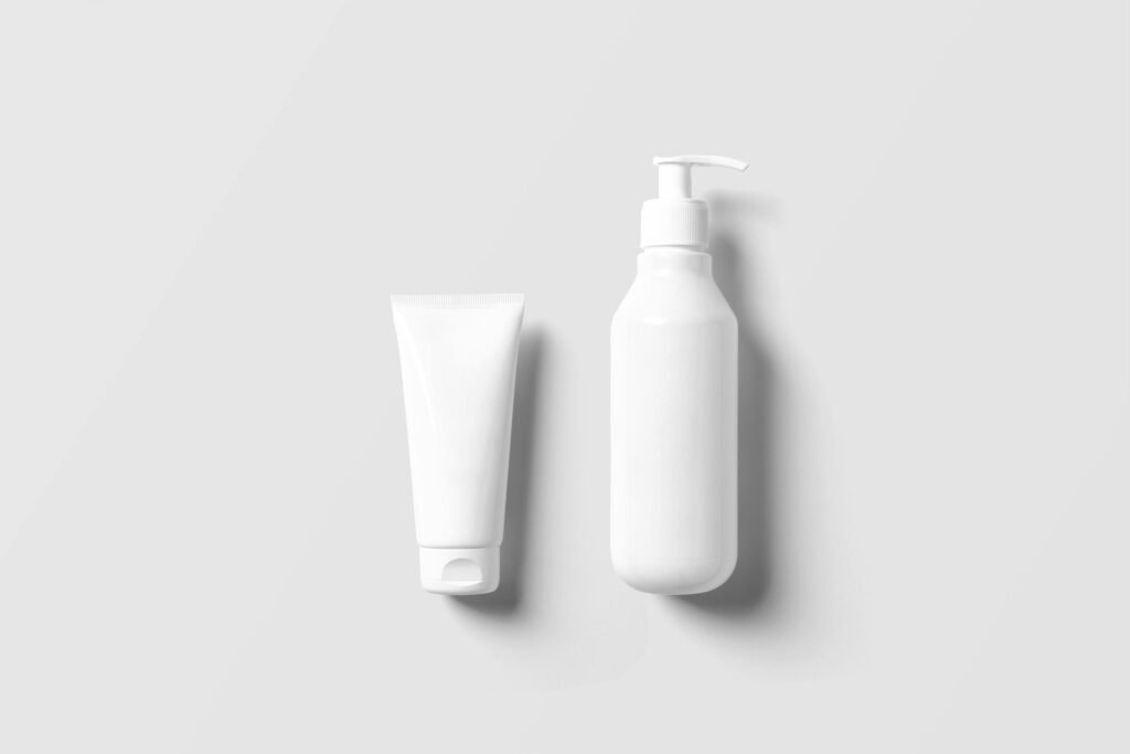 Clean and minimalist display of a white pump bottle and tube on a white background.