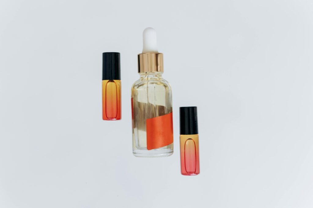 Stylish glass bottles with droppers and colored gradient design, perfect for essential oils and aromatherapy.