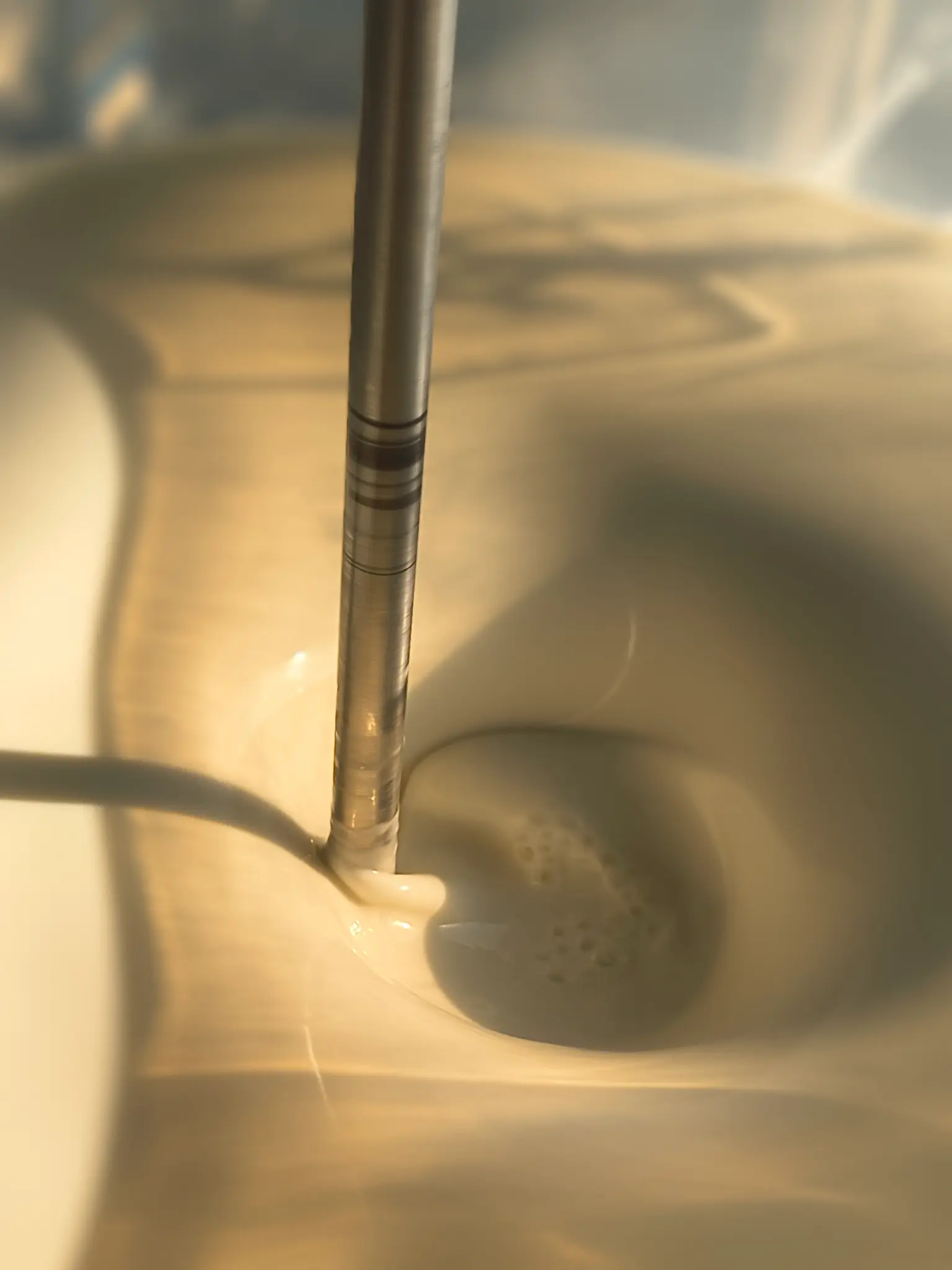 Stainless mixing shaft blending a cosmetic emulsion in a Formyoule&trade; Inc. laboratory vessel